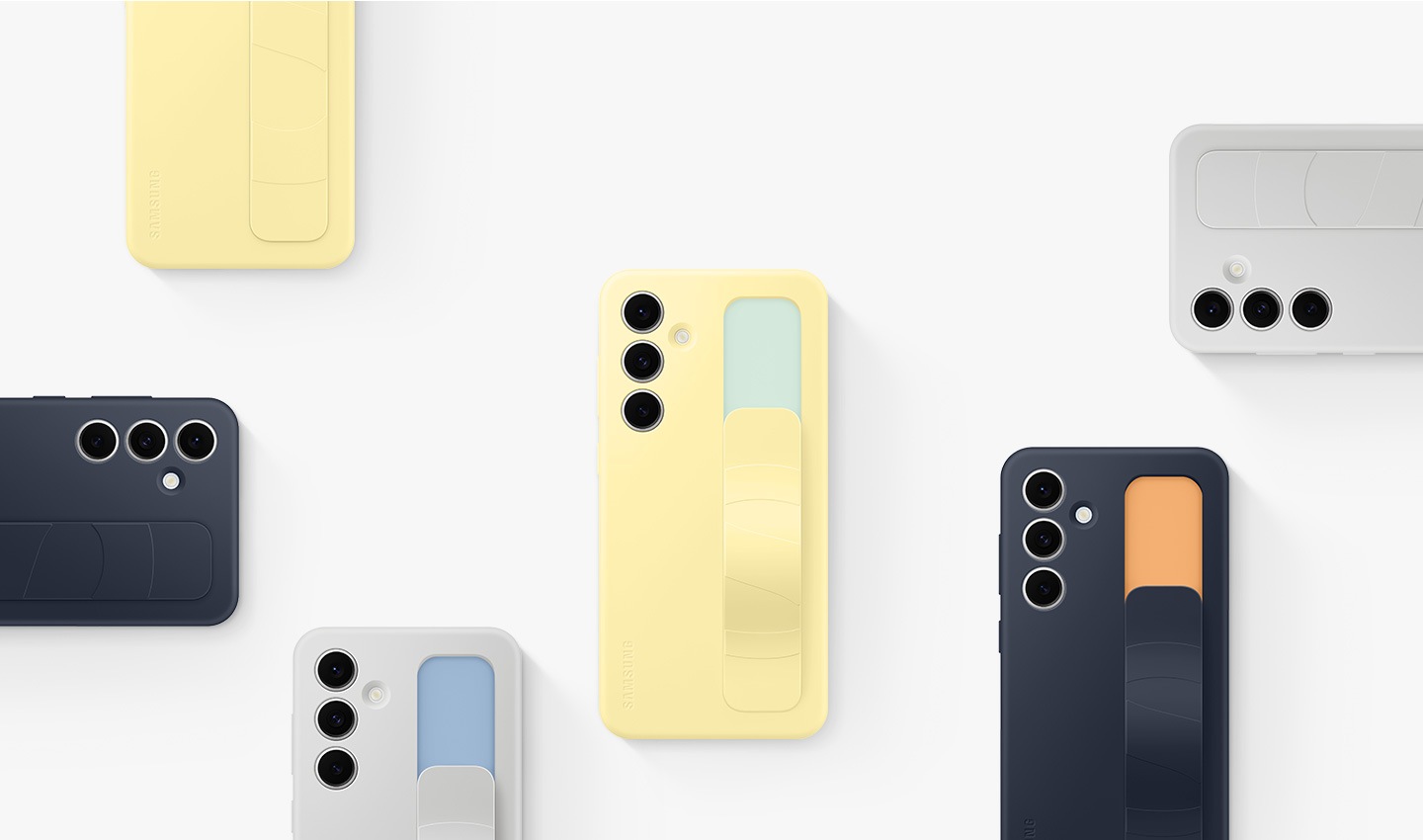 Se muestran varios dispositivos Galaxy S24 FE con cubiertas de agarre vertical en Blue, Black, Yellow y Gray. Están dispuestos de manera ordenada, mostrando sus partes posteriores.