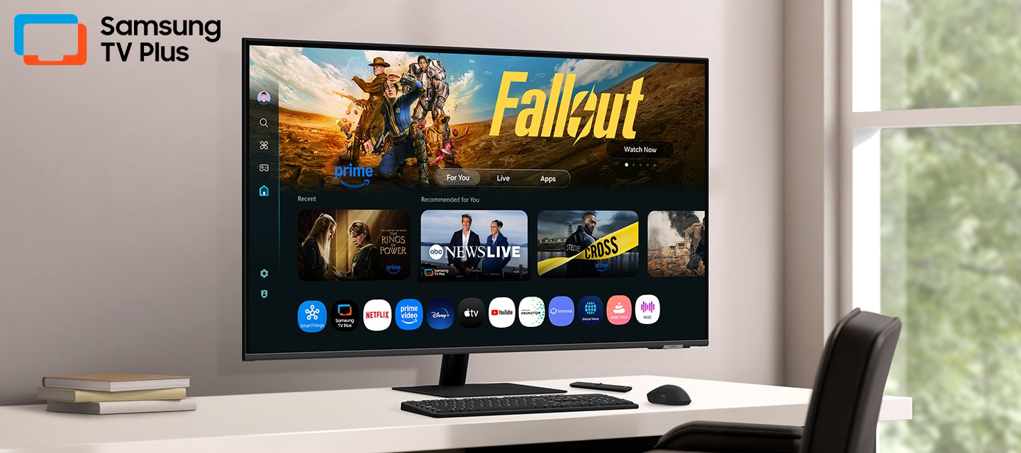 El monitor del escritorio muestra la página Smart TV Apps con varios contenidos y aplicaciones alineados. Logotipo de Samsung TV Plus.