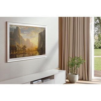 The Frame TV with the Sand Gold, Beveled Bezel is mounted in a living room.