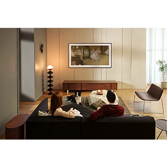 Users enjoy The Frame TV with its Brown Modern Bezel mounted on their living room wall.