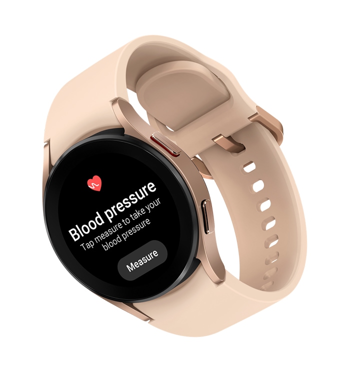 A Galaxy Watch4 device in pink gold color attached with a pink band is shown. On the watch face, the menu for Blood Pressure measurement features are displayed.