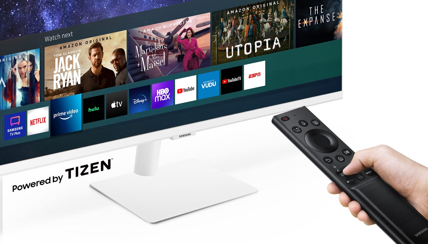 Entertainment apps are displayed on the monitor. A person flips through apps with the monitor's remote control. All this features is powered by Tizen.