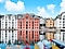 Wide angle icon activated, the shot includes only the tip of the canoes and a portion of the buildings. wide angle are above a landscape of yellow and red canoes lined up in a pier with white and red buildings in the far background.