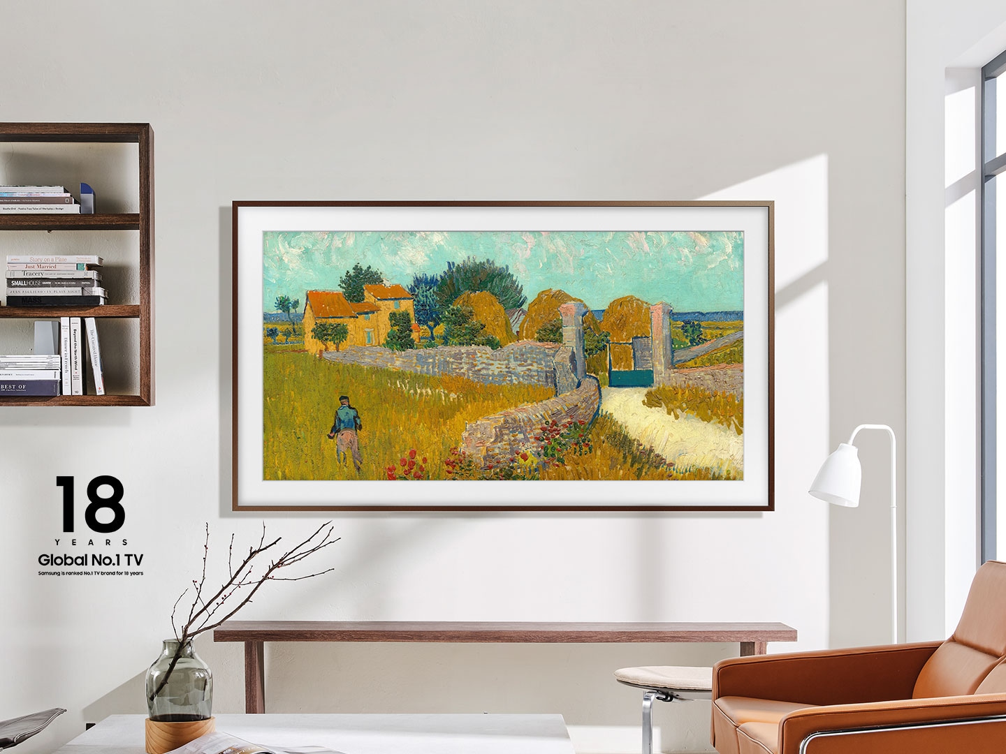 The Frame is hanging on a wall in a living room displaying a sunset over a city.