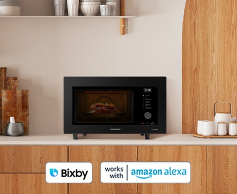 Shows the microwave with Samsung Bixby, works with amazon alexa logos, as it can be controlled by voice or app.