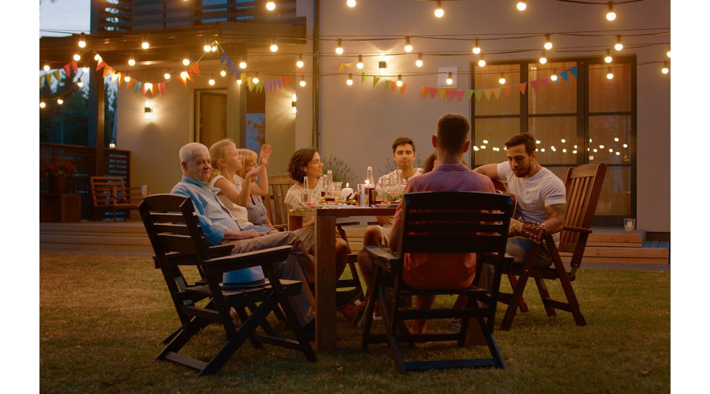 There is a video in low resolution. The NQM AI Processor appears and analyzes the contents. Then, the overall resolution is enhanced. Lastly, the scene is zoomed out showing the monitor with the video and its remote controller.