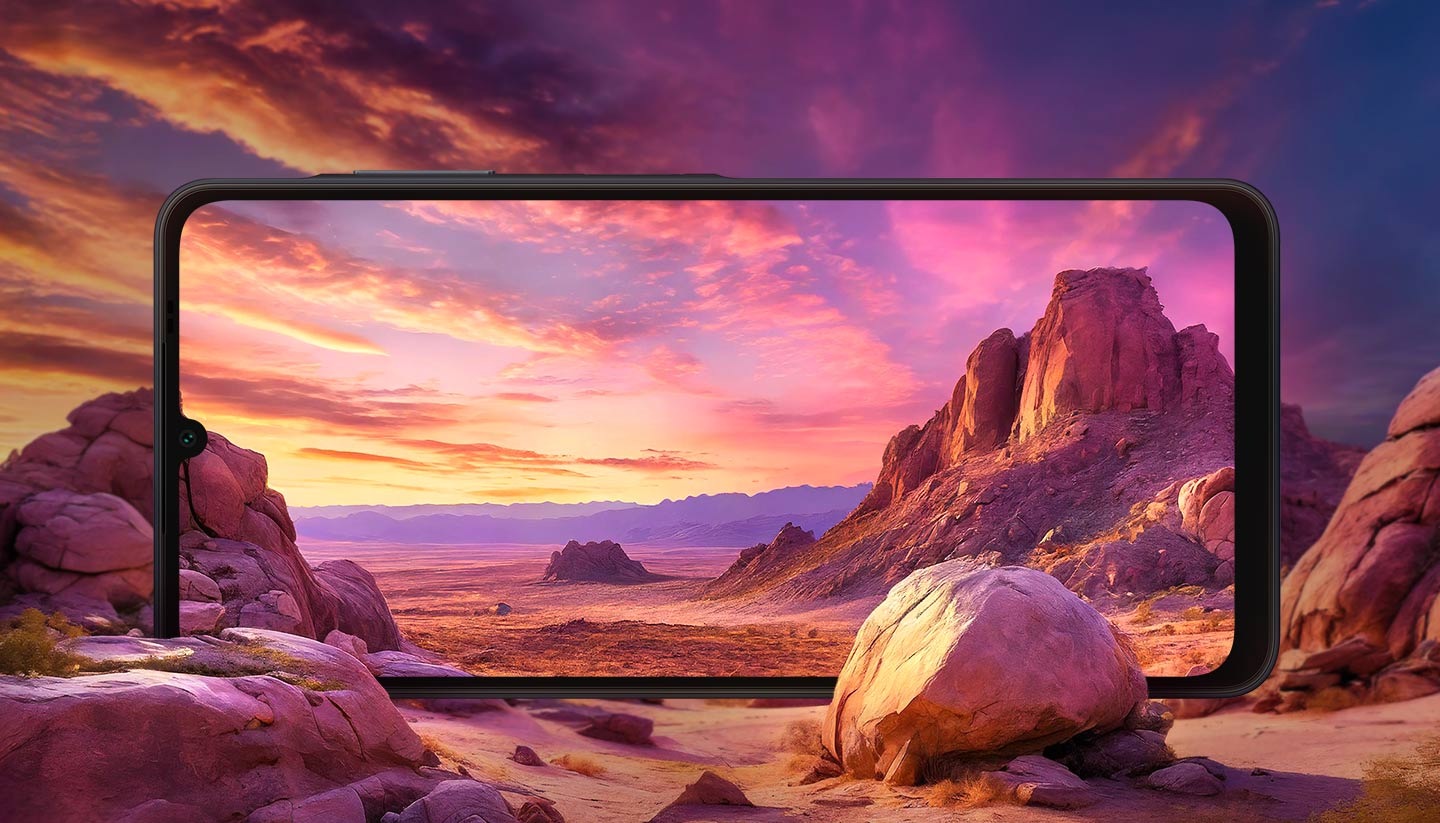 The Galaxy A06 screen seamlessly blends into a desert landscape with rock formations in the background.