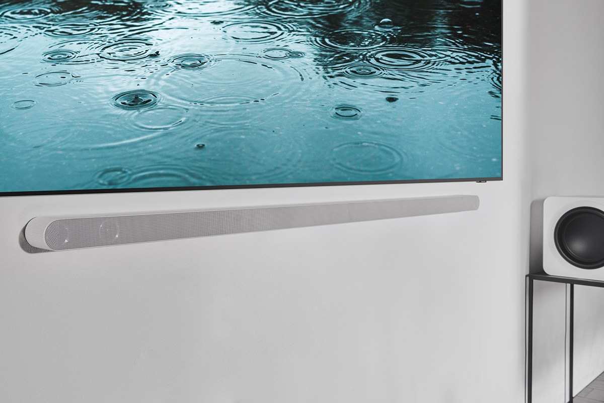 Samsung TV with the ultra slim soundbar is hanging on the living room.