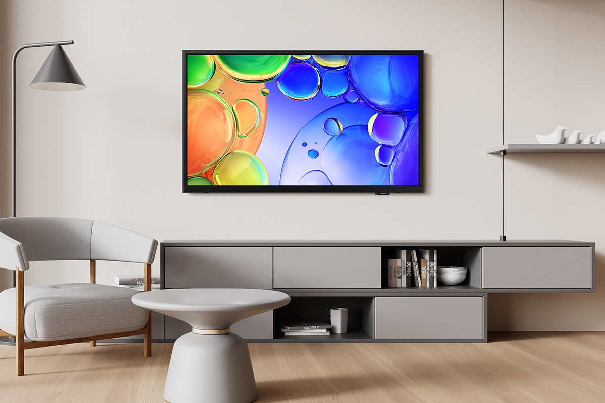 Q5F is installed on the wall of a modern living room. It displays a colorful abstract image with vivid details.