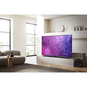 A Neo QLED TV is displaying purple graphic in a room. 