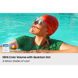A scene of a woman in a pool spitting out water. Logo reads VDE 01/2025 Tested Color Volume 100% acc. to DCI-P3. www.VDEinfo.com. ID 40059611. Tested by VDE Germany. Another logo is made of stacked color wheels that represent Brightness. 
