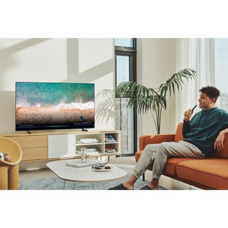 Samsung QLED Q60B with Voice assistant is displaying picture in the living room