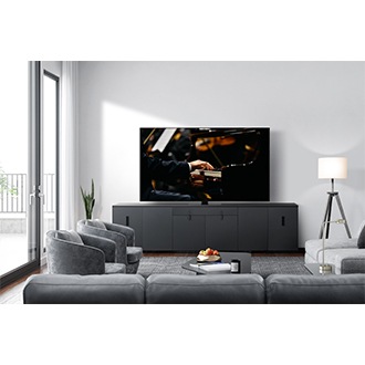 QN87D on a console in a modern gray-toned living room.
