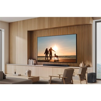 Wall-mounted QN87D and Soundbar in a wood-toned living room.