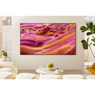 A Neo QLED TV is installed on the wall of a sunny room. The screen displays a colorful abstract landscape.