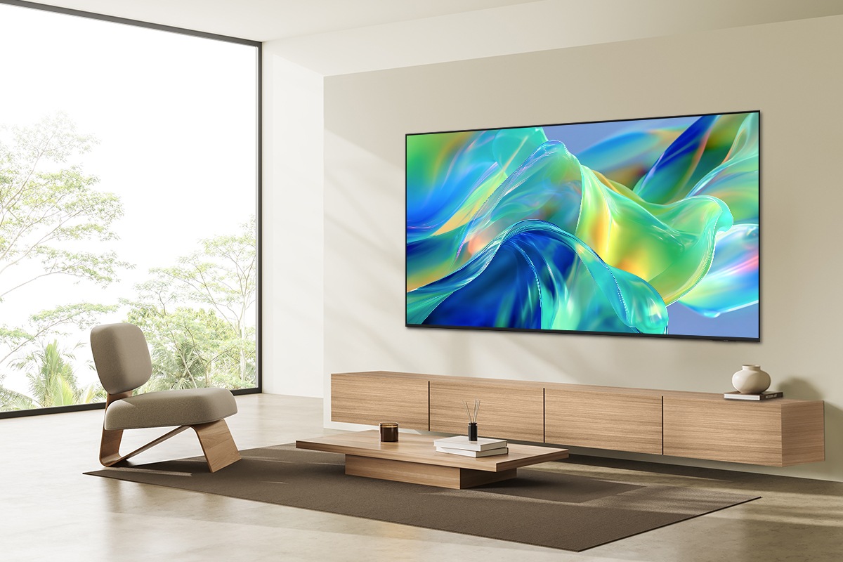 Samsung M1EH TV mounted on the wall in a bright living room displaying a vibrant abstract  scene.