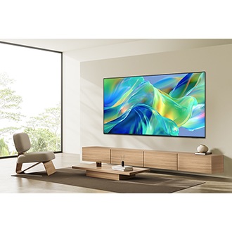 Samsung M1EH TV mounted on the wall in a bright living room displaying a vibrant abstract  scene.