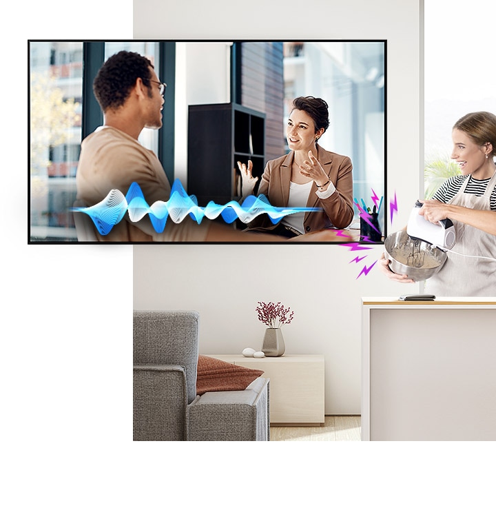 A woman is cooking while watching TV. Despite the noise coming from the mixer, the Active Voice Amplifier technology makes it easy to hear TV conversations.
