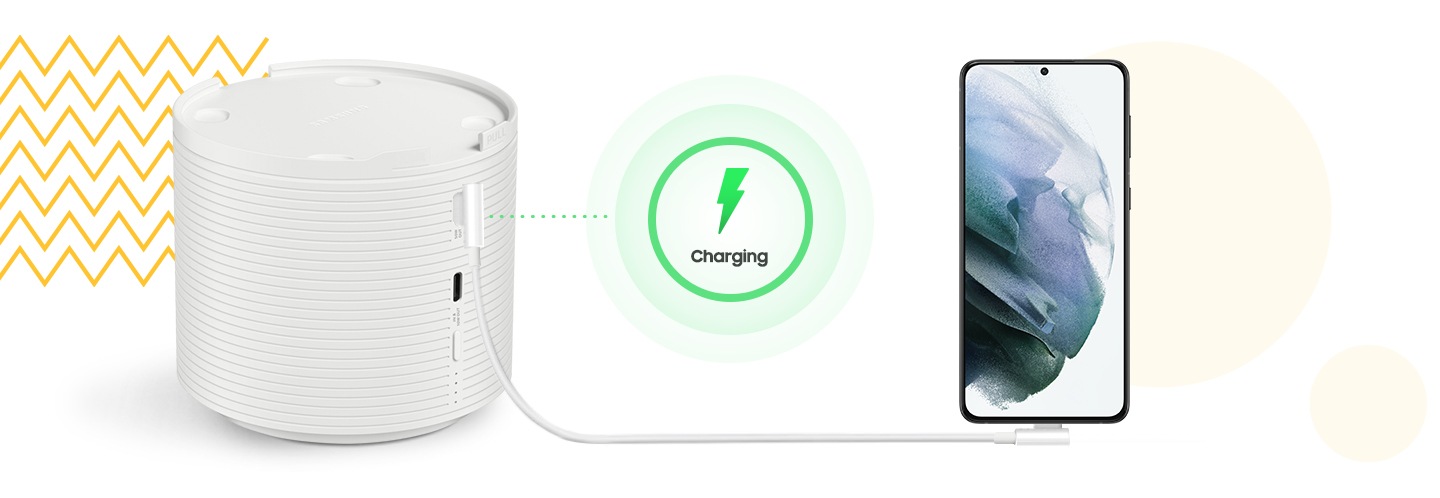 A smartphone is charging with The Freestyle Battery Base via a cable.