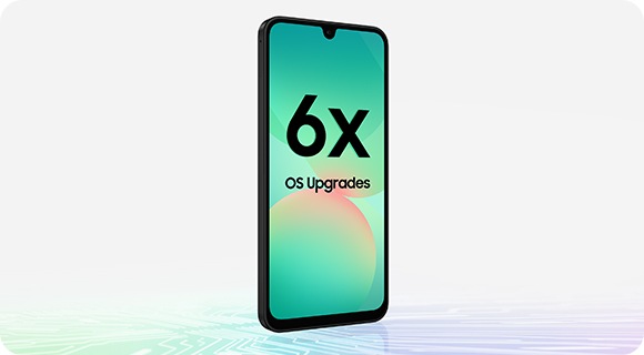 Galaxy A26 5G in a slightly tilted front view. Text 6x OS Upgrades is onscreen. Chipset-like design is at the bottom.