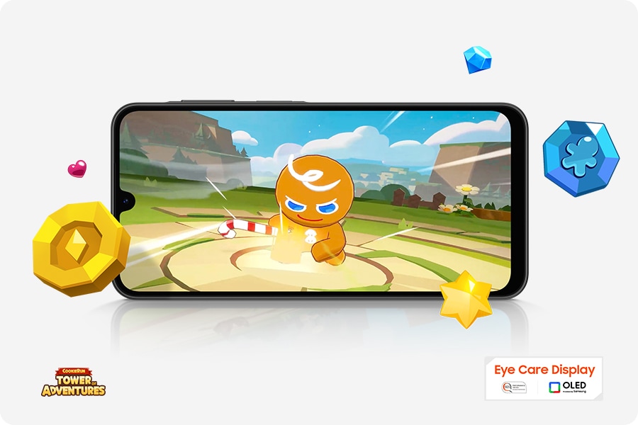 A Galaxy A26 5G device running the mobile game Cookie Run in landscape mode. Game items are scattered around the screen. Nearby are the COOKIE RUN TOWER OF ADVENTURES logo and the Eye Care Display and OLED technology logo.