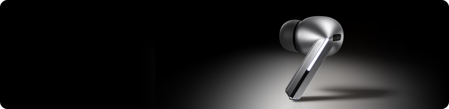 A single, silver colored Galaxy Buds3 Pro earbud with the Blade Light on.