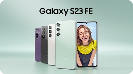 Five Galaxy S23 FE devices in Purple, Graphite, Cream and Mint. Four are seen standing upright from the rear overlapping on top of each other. The other one is seen from the front with a woman up-close onscreen smiling at the camera.