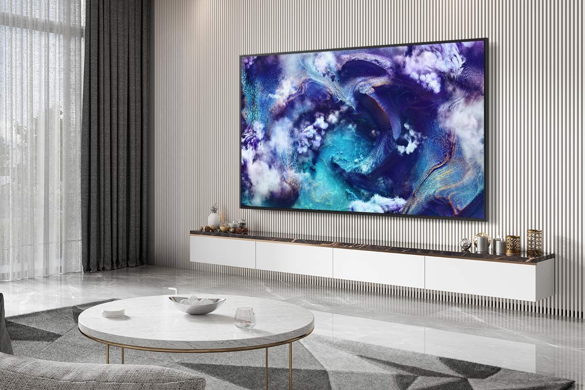 A Neo QLED TV is installed on the wall of a modern living room. The screen displays a vivid blue waves.