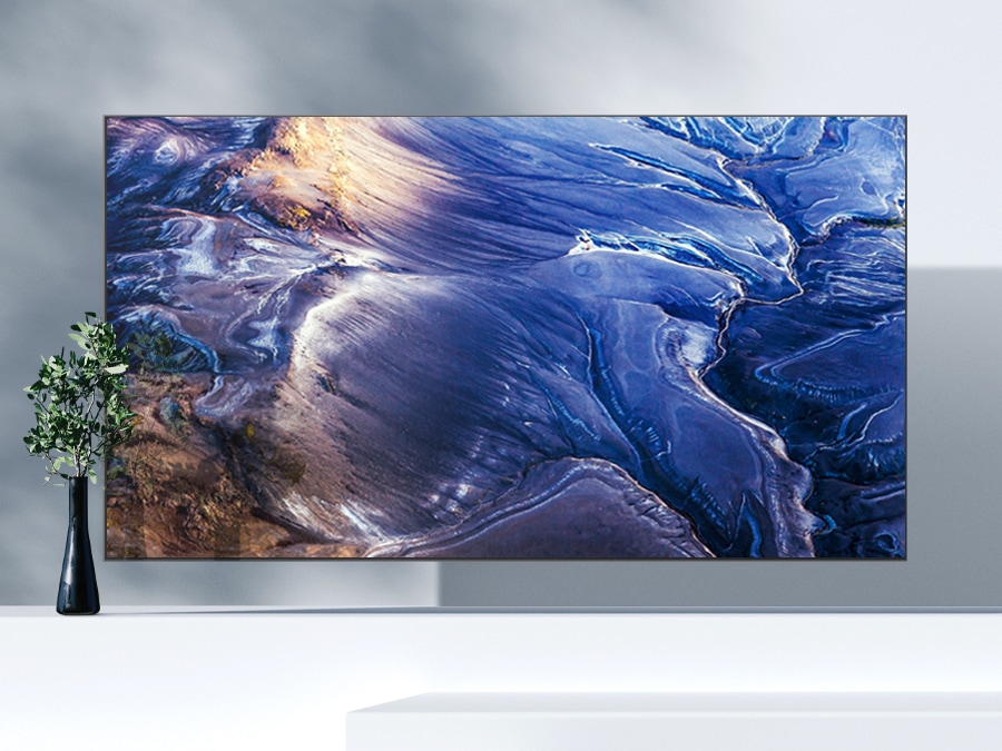 A QLED TV is showing a matte wave-like blue graphic on the screen without any light reflections.