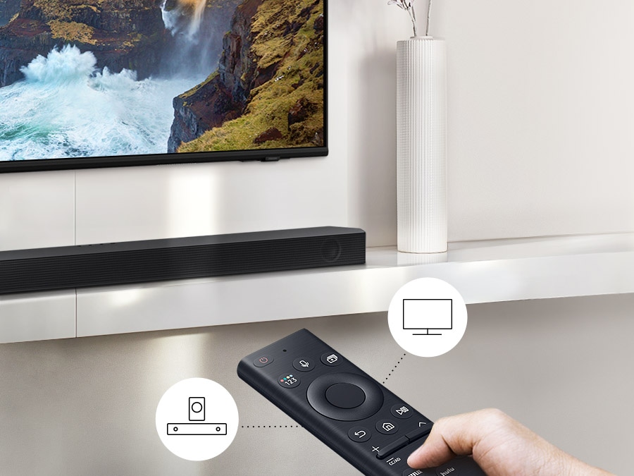 A user controls both soundbar and TV functions with Samsung TV remote.