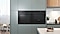 Shows the built-in oven seamlessly installed in a kitchen next to a Microwave Combo oven. Its BESPOKE "Black Glass" color elegantly complements and enhances the kitchen's color scheme.