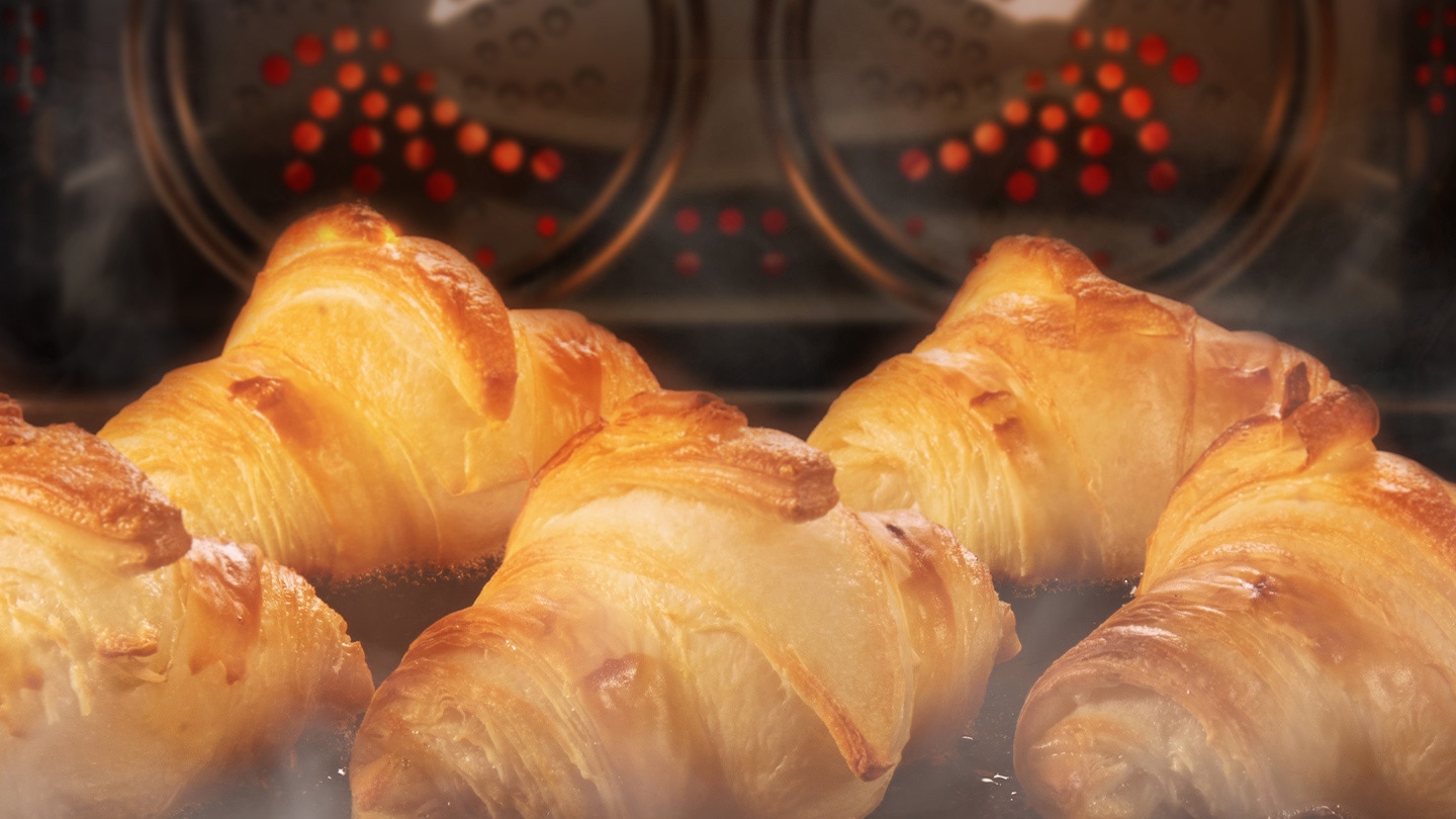 Shows a close-up of croissants being baked in the oven using the convection system, but being kept moist with steam using the Add Steam option.