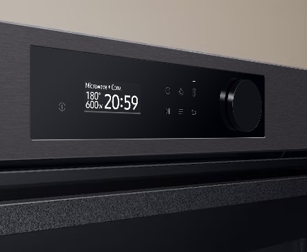 Shows a close-up of the oven's stylishly minimalist control panel with an LCD display, touch control and a single knob.