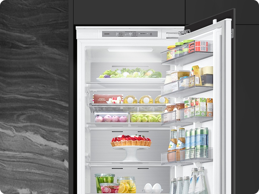 The refrigerator's lighting adjusts to match the surrounding environment, revealing its interior.