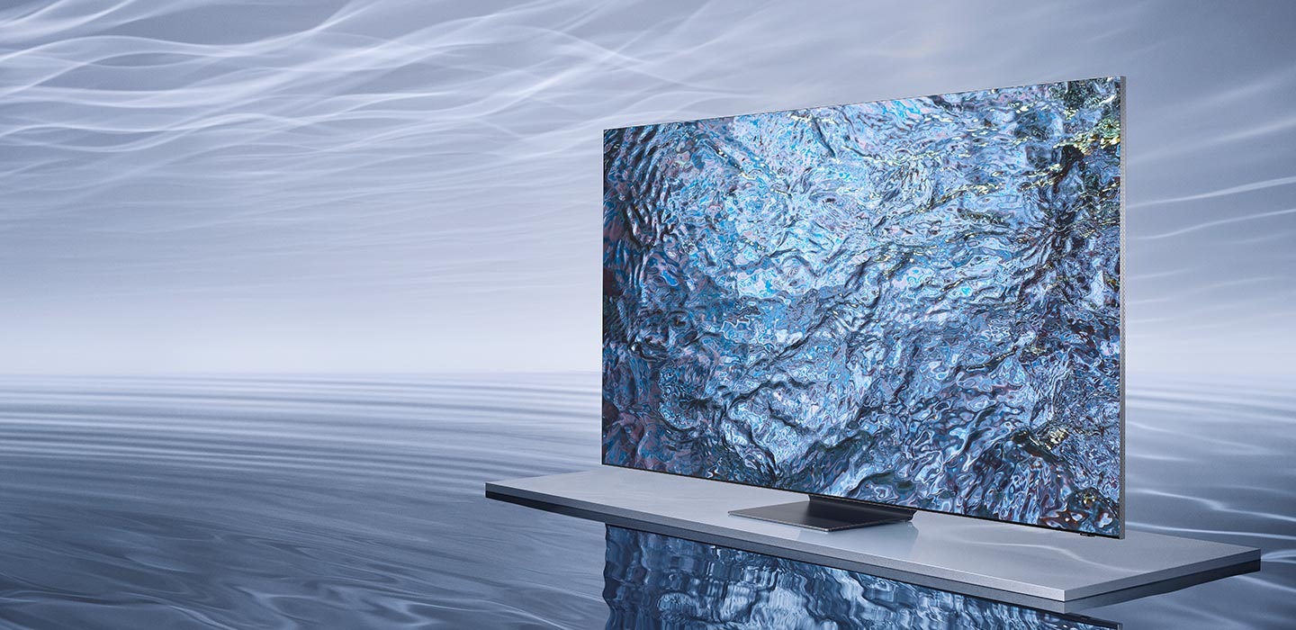 A Neo QLED TV is on display on top of a gray surface.<br>It's floating on a water-like background.