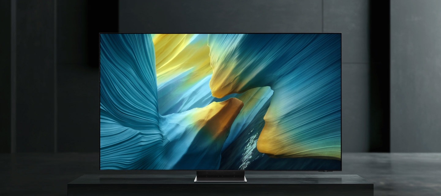 Close-up view of the top of a TV, with a glowing line tracing over the edge. Close-up view of part of the front screen, with a glowing line tracing over the edges. A side view of the slim TV screen as a glowing line traces over it. The TV rotates to display a colorful abstract landscape on screen.