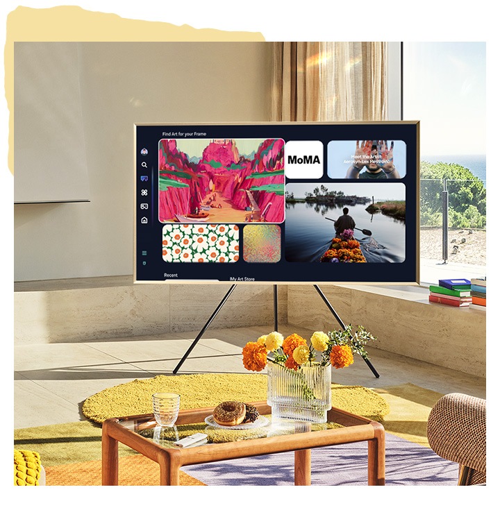 The Frame TV on Studio Stand in living room setting shows Art Home screen with some of the artwork available in Art Home.