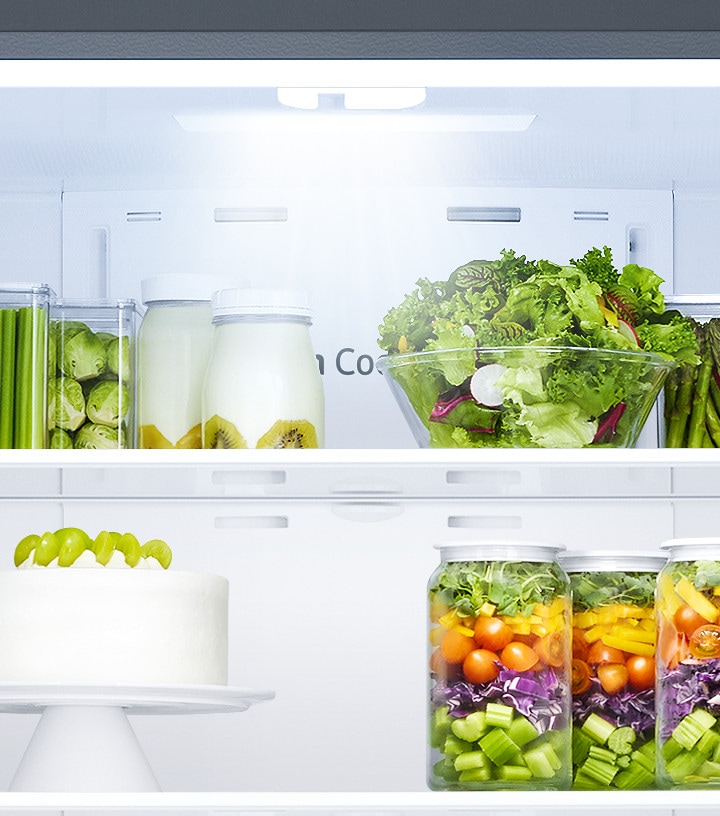 All the doors of the RF5000A are open, while LED lighting illuminates the food in the fridge and freezer chambers.