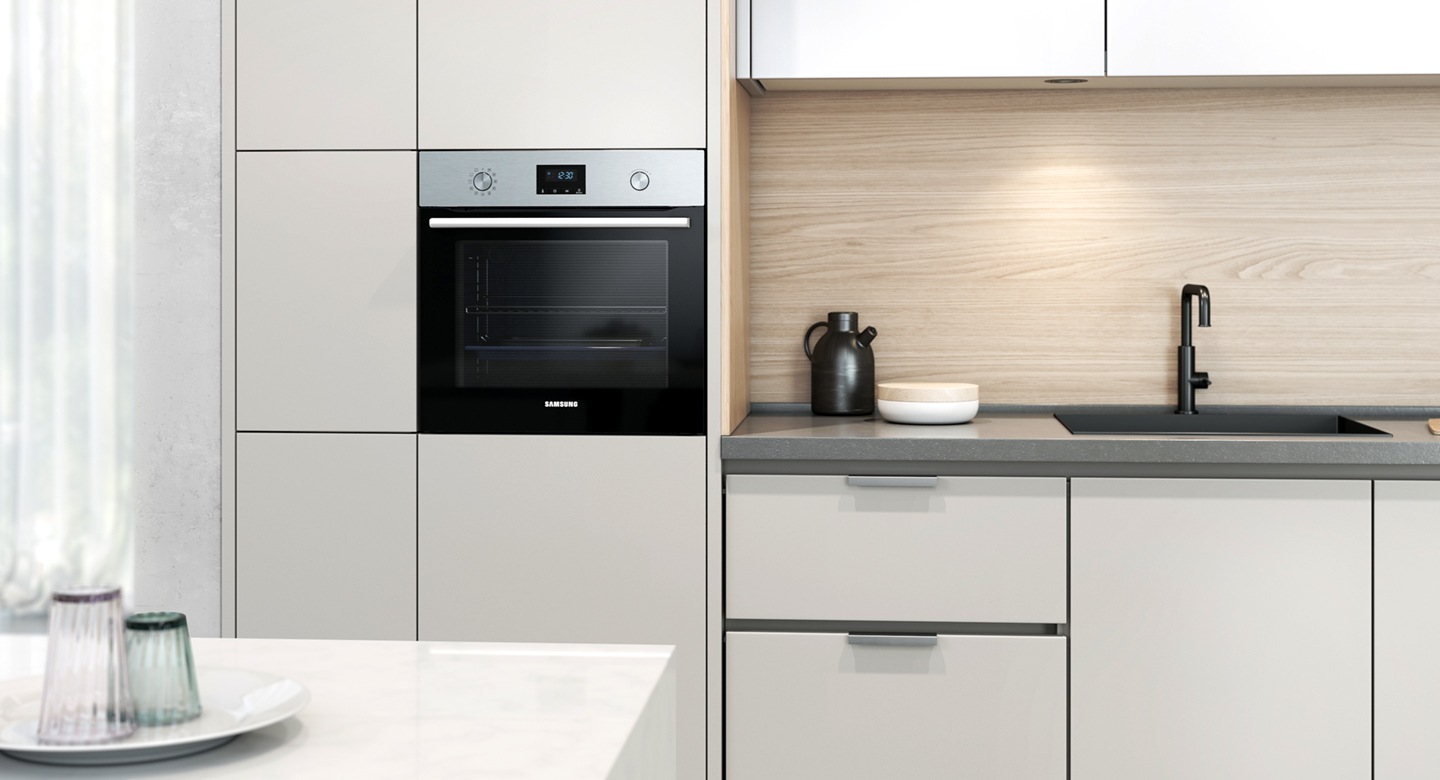 Shows how the oven fits seamlessly into the wall of a modern kitchen.