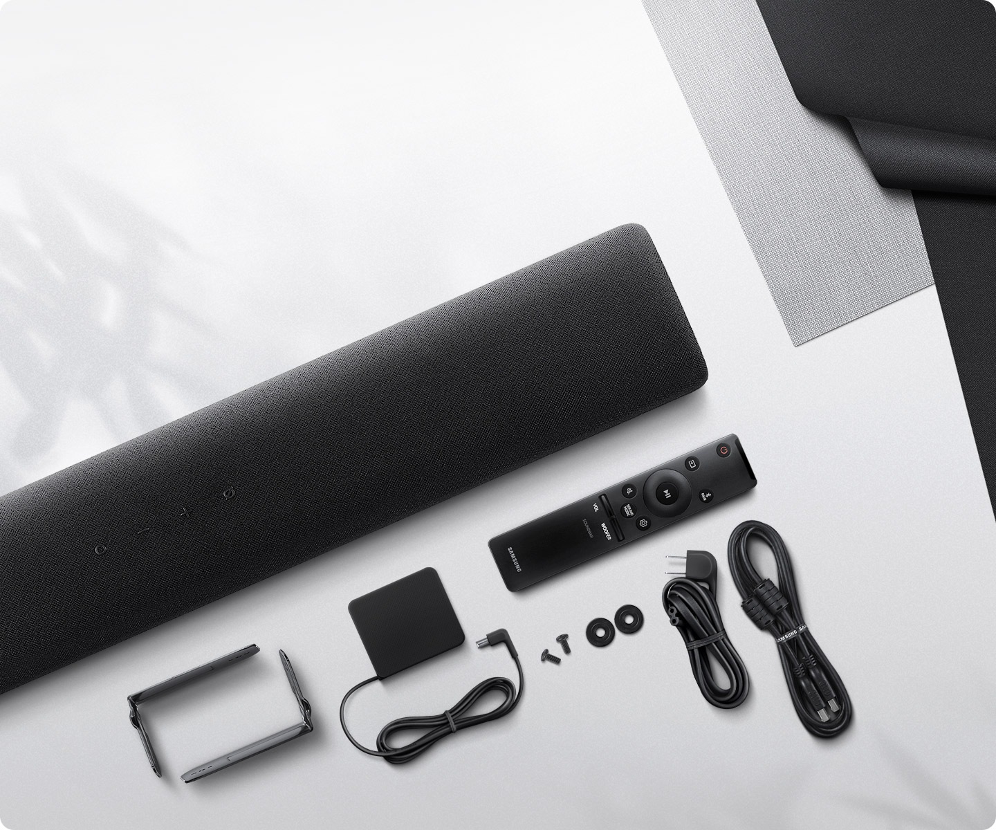 An overview angle shows everything that comes included with S60A Samsung Soundbar including wallmount installation brackets.