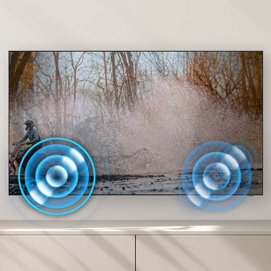 A person on a motorcycle is zipping past from one side to another. Built-in speakers follow the sound of the motorcycle as it moves.