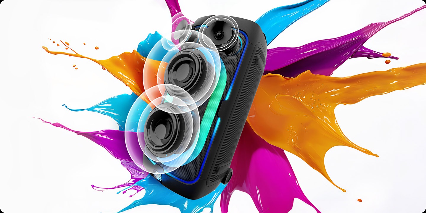 Sound Tower against paint color splash background plays powerful sound, as shown by soundwaves coming from the speaker cones.