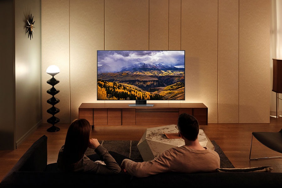 2 people are watching a movie on the QLED TV.