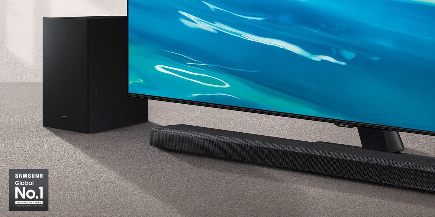 Samsung Global No.1 logo can be seen along with Samsung Q700A Soundbar and subwoofer which are positioned next to QLED TV.