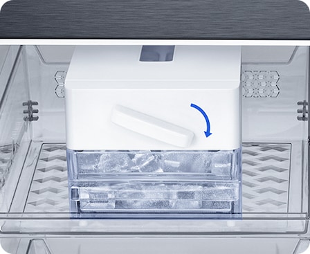 Twist Ice Maker is on a shelf in the freezer. With a twist, lots of ice falls into the removable storage bin below.