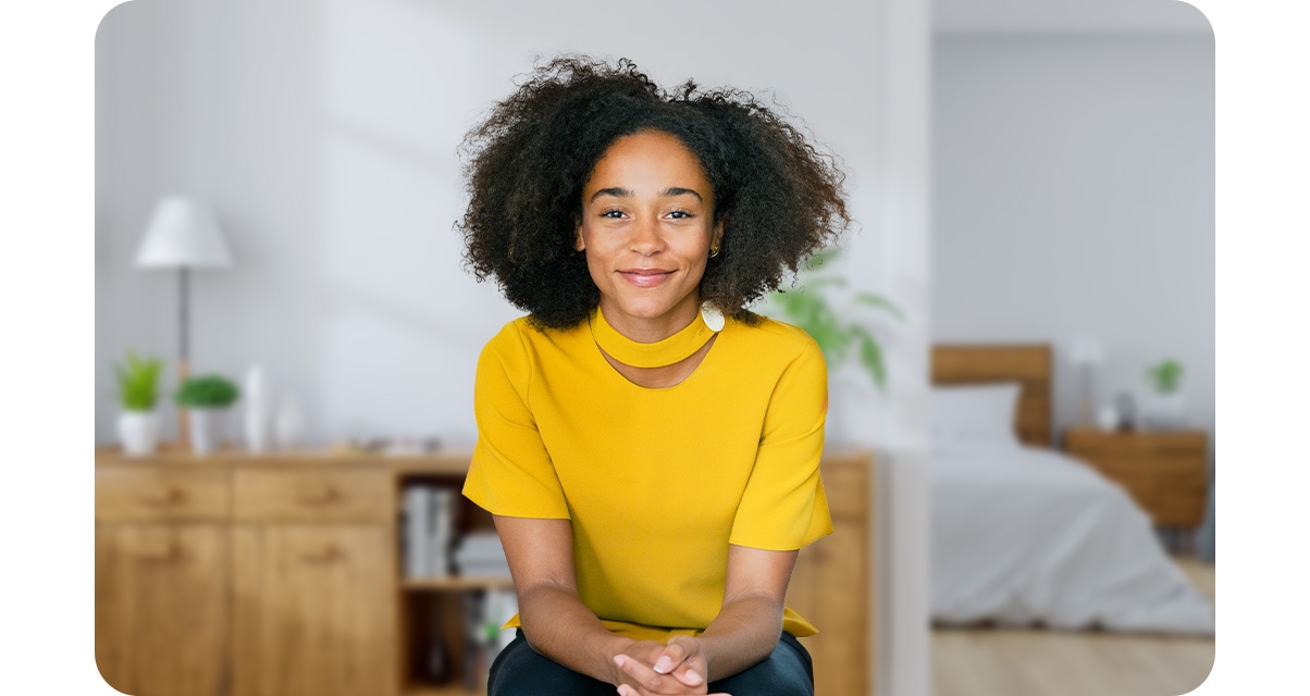 Samsung galaxy a22 5g taking a portrait of a woman in a home with the depth camera. Her bedroom and bookshelves in the background are blurred out with portrait on feature.