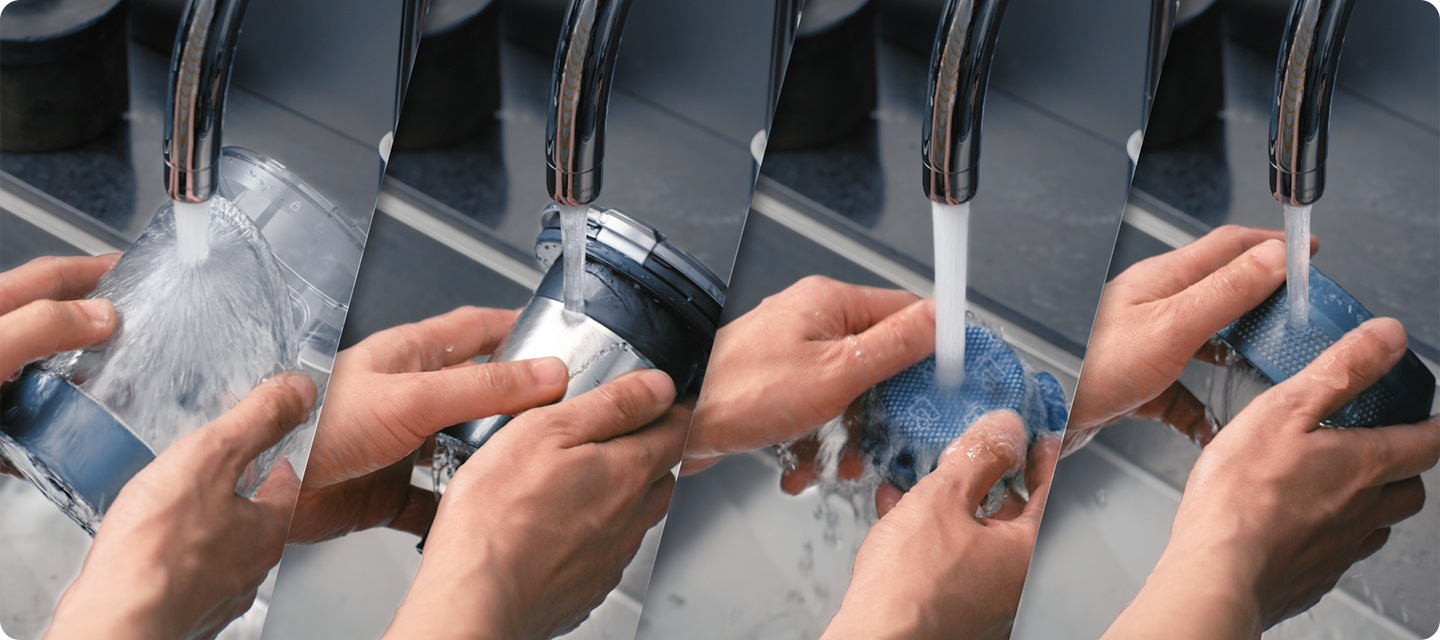 A Bespoke JET's 4 Dustbin parts get handwashed under a tap. The 4 parts are the Dustbin, Cyclone, Micro Filter, and Fine Dust Filter.