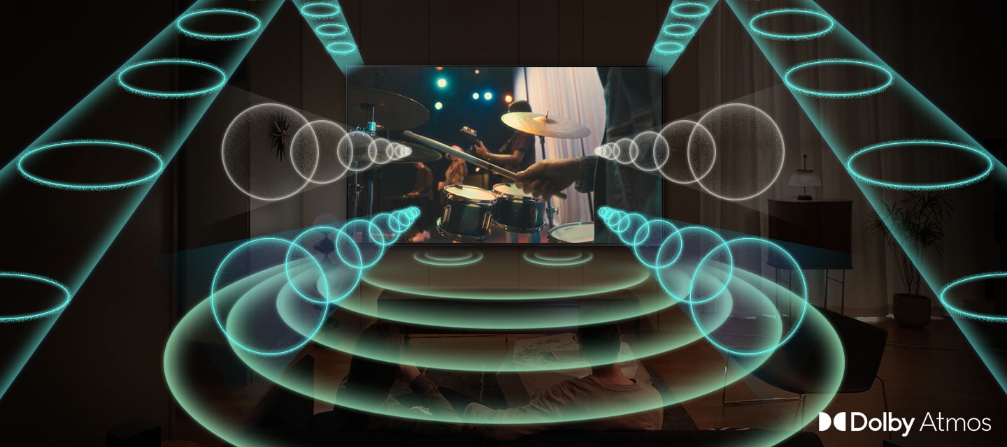A Samsung TV plays a scene of a band performing, with a focus on the drummer. The TV emanates rings of sound in various sizes, which pulse energetically and travel in all directions to fill the space, indicating use of the Dolby Atmos feature.