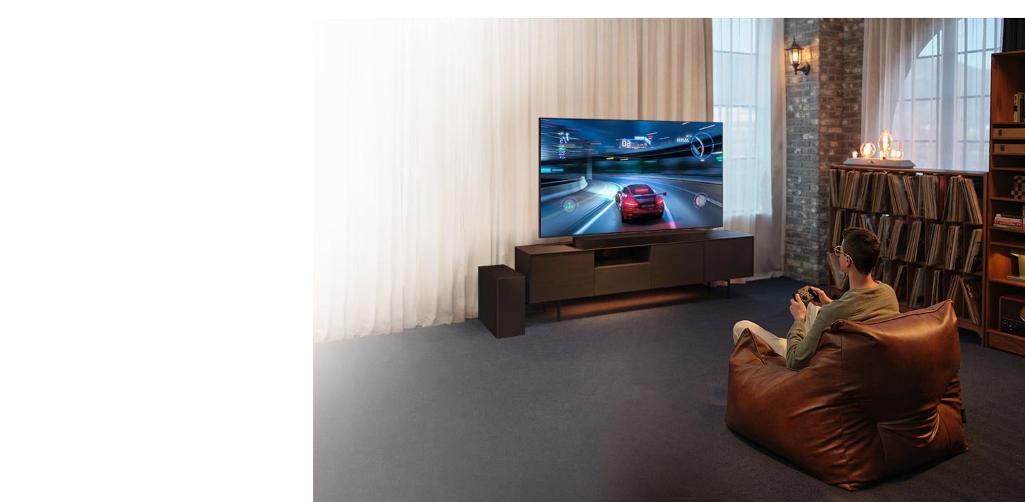 A man enjoys an immersive 3D-like gaming experience with Samsung Soundbar Game Mode Pro.