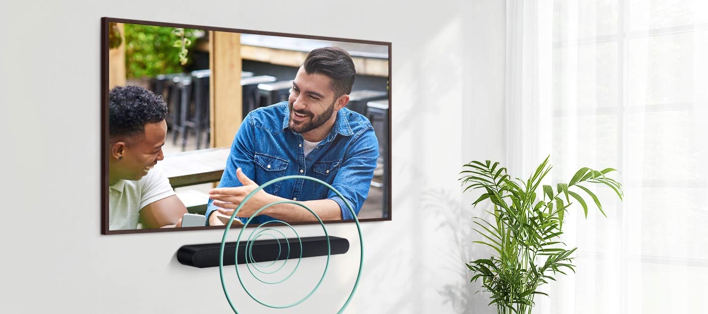 A TV shows a scene of two men talking. Installed under the TV, a Soundbar gives off round sound waves indicating voice audio.